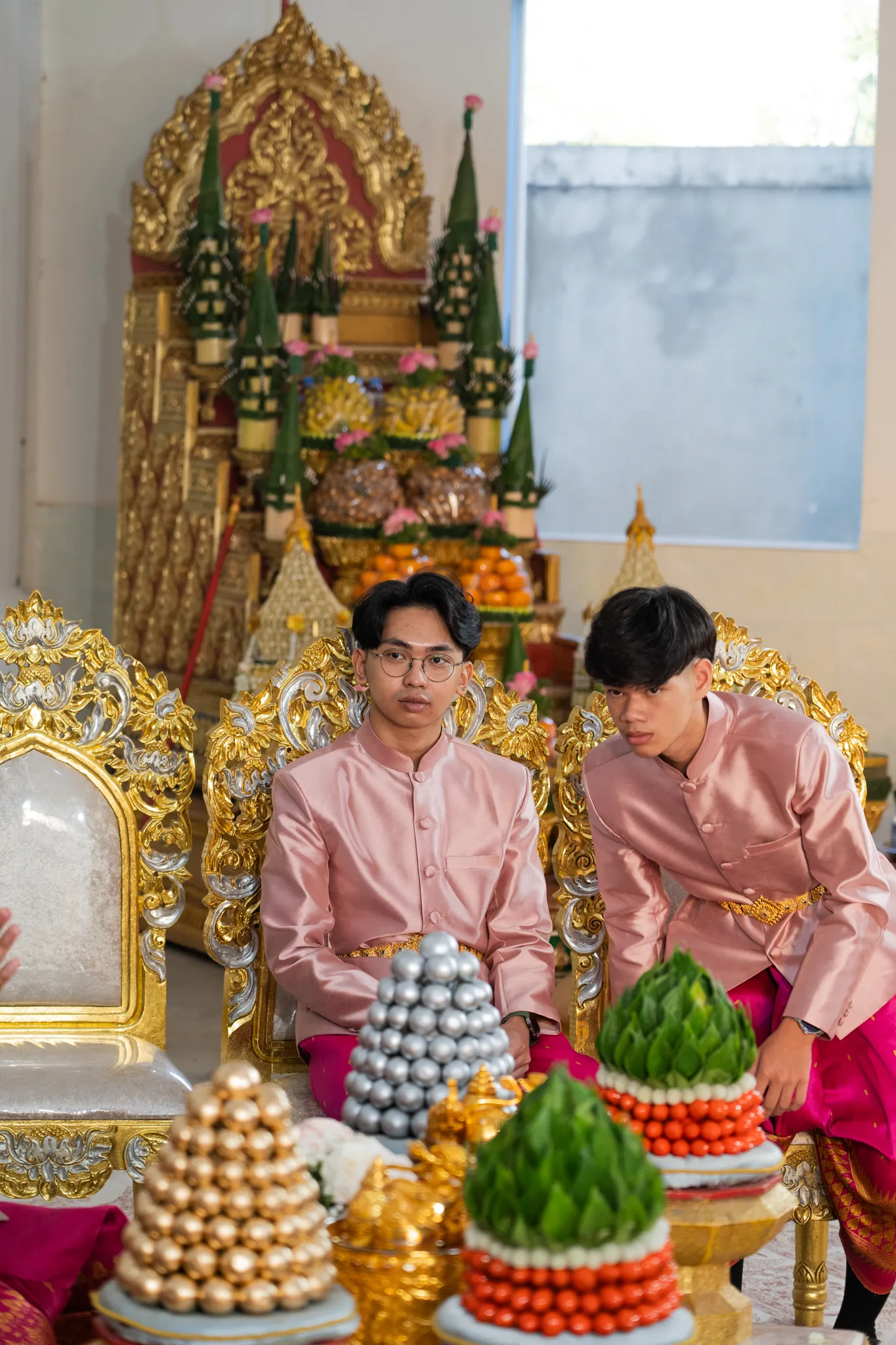 Groom seated at the altar amid ceremonial offerings