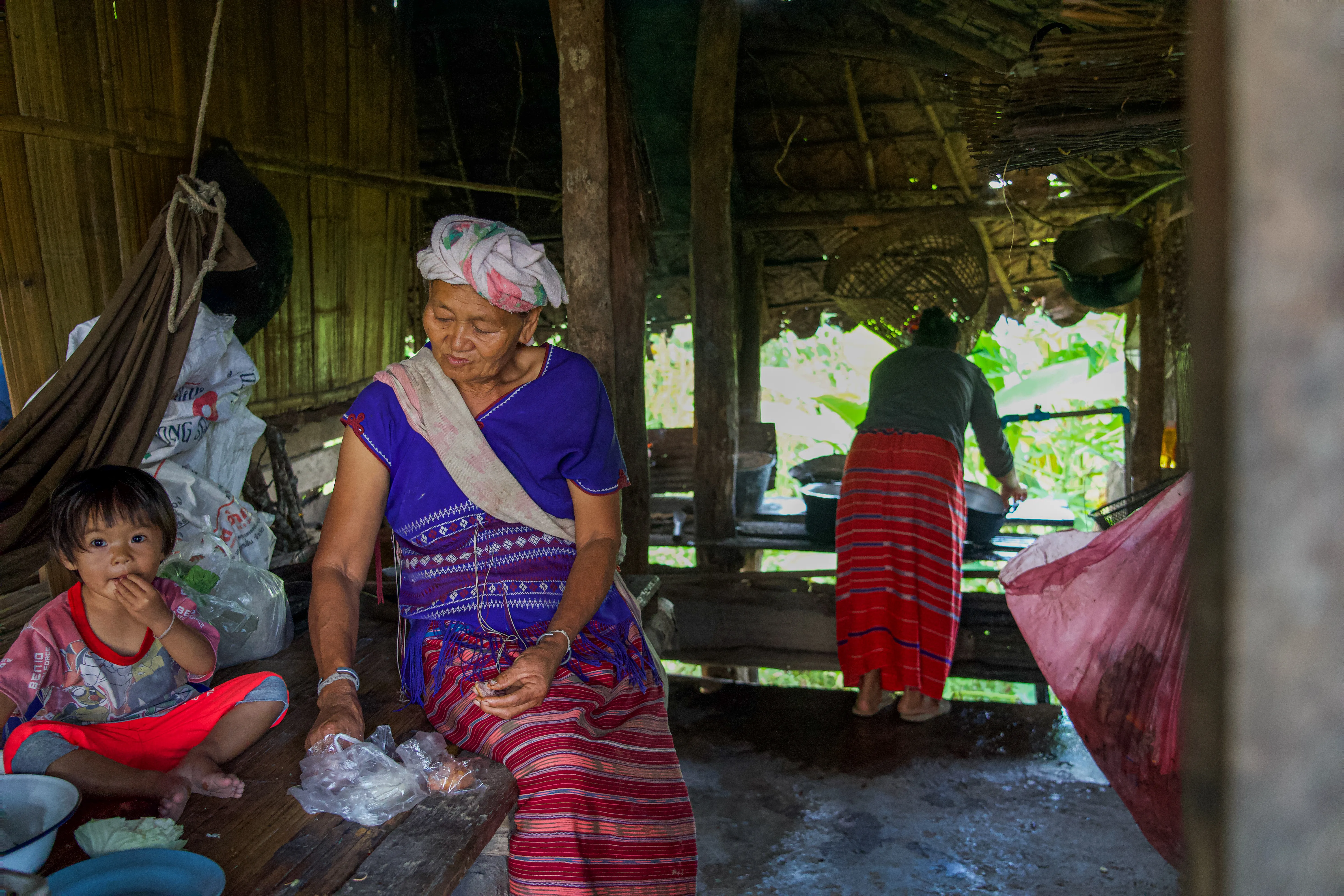 Grandmother and child in a stilt-house kitchen