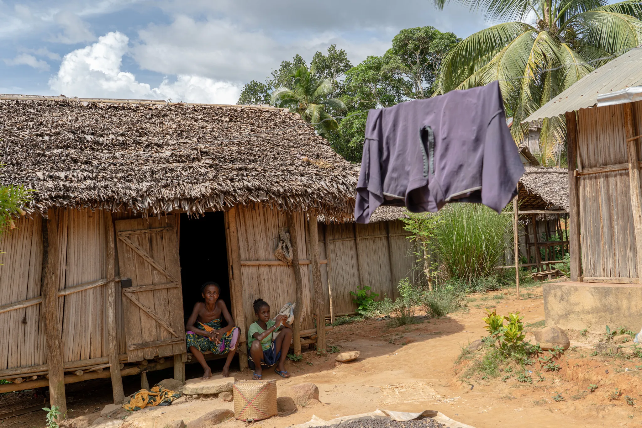 Laundry drying outside a thatched home