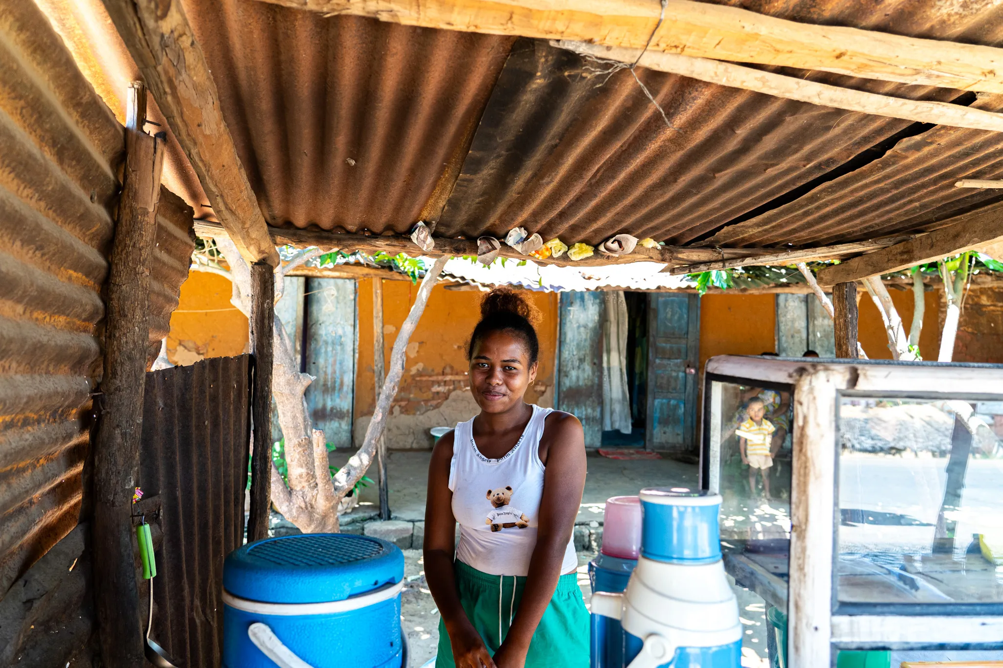 Portrait of a young woman under a tin roof