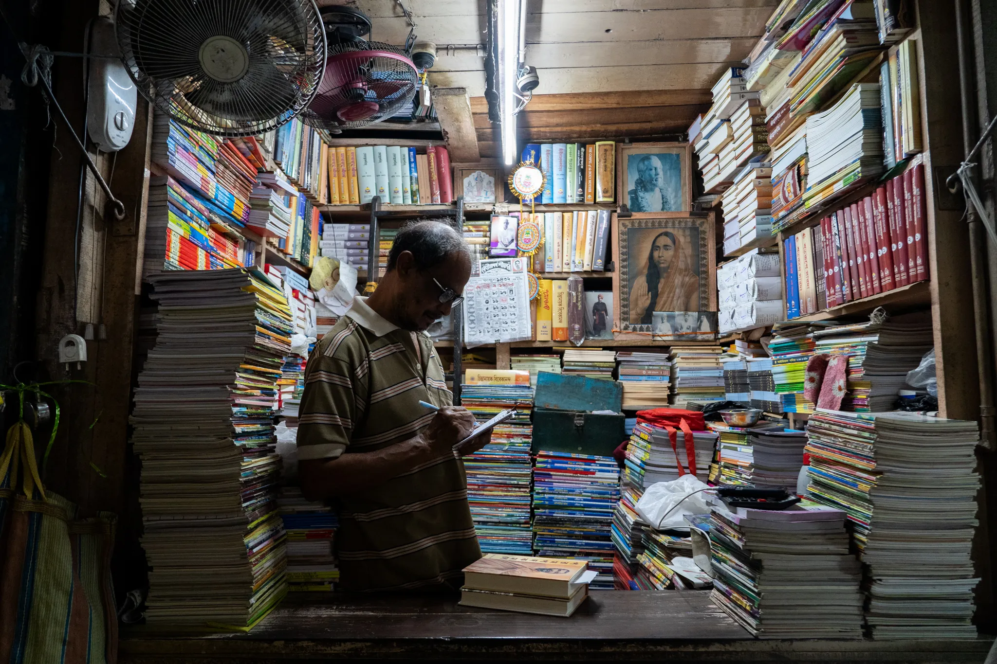 Sorting through towers of books, India