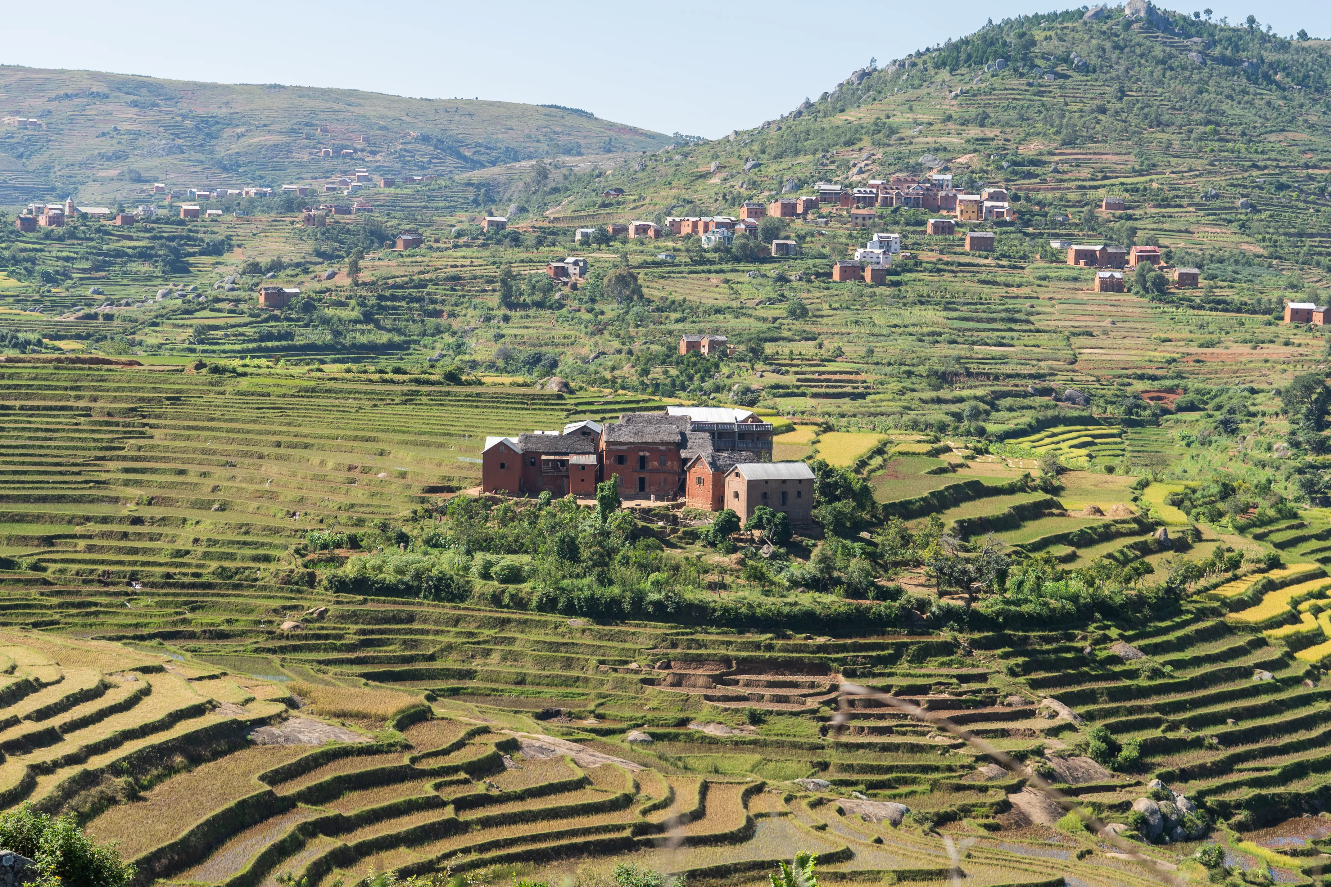 Large brick homestead surrounded by rice terraces, Madagascar