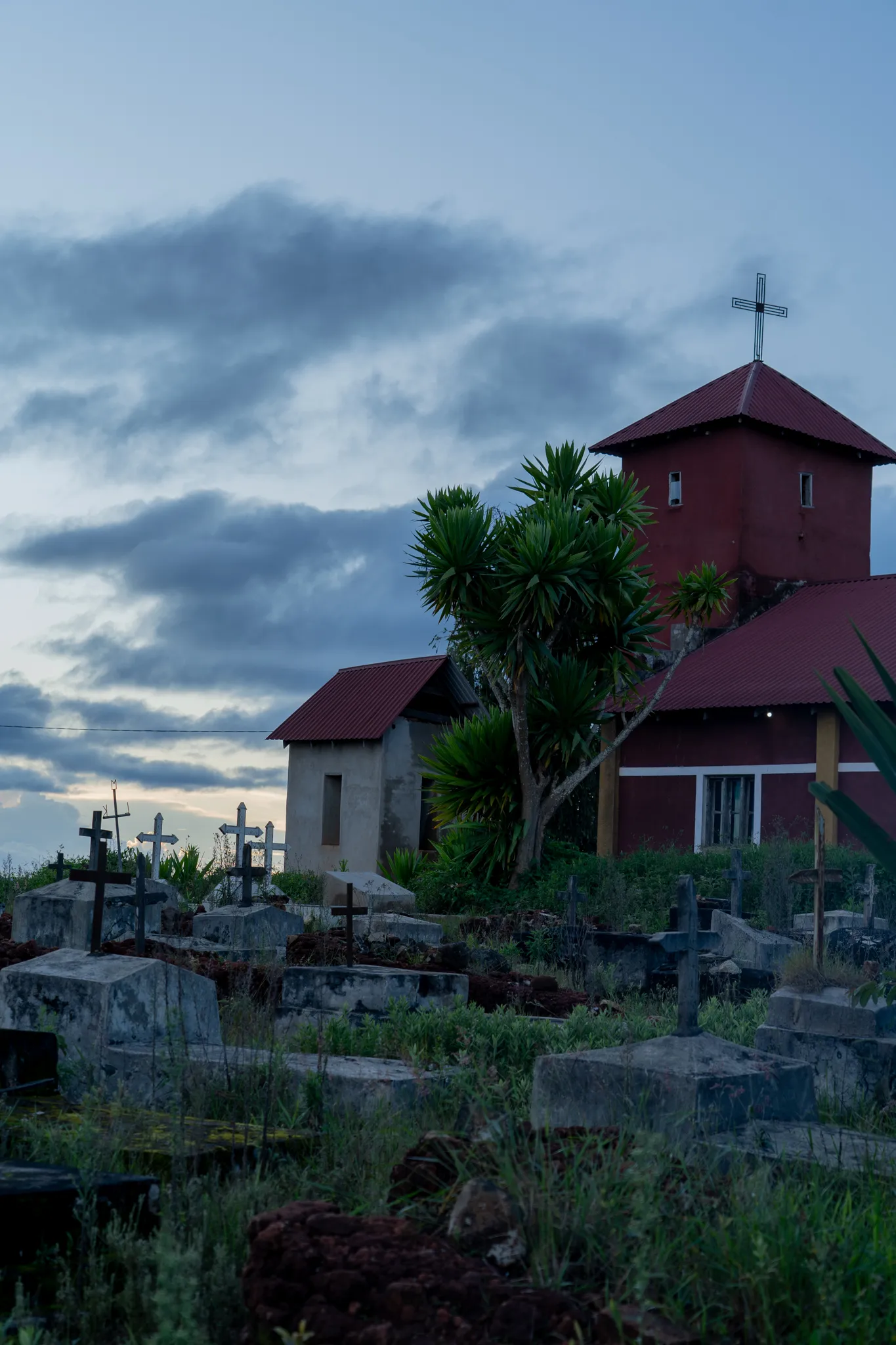 Cemetery crosses below a hillside chapel, Tanzania