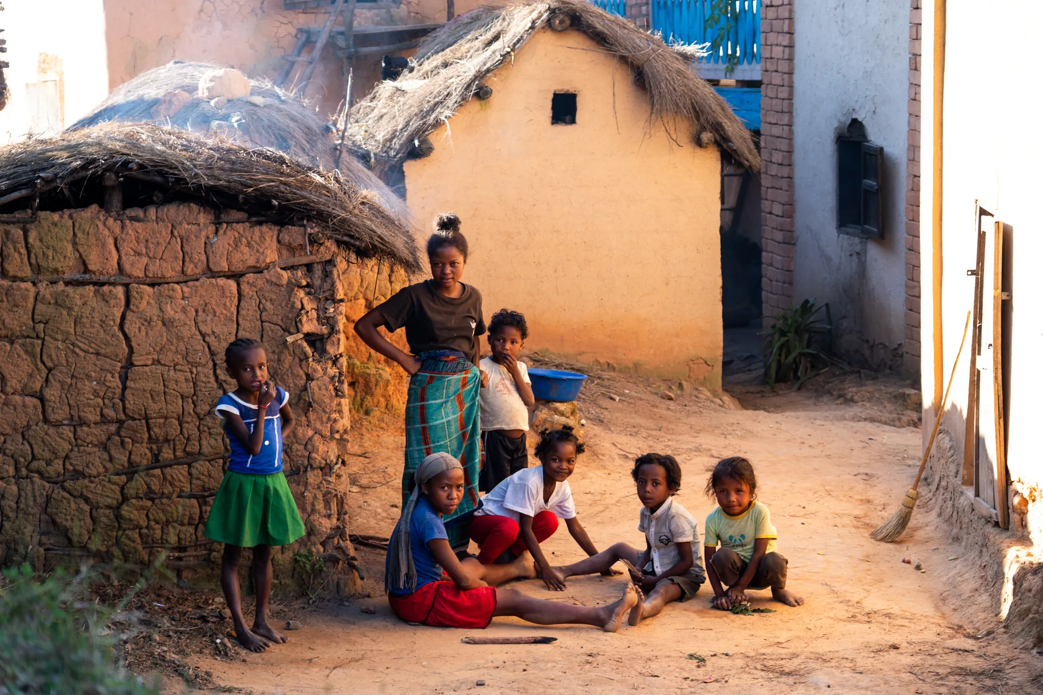 Children in a village alley at golden hour