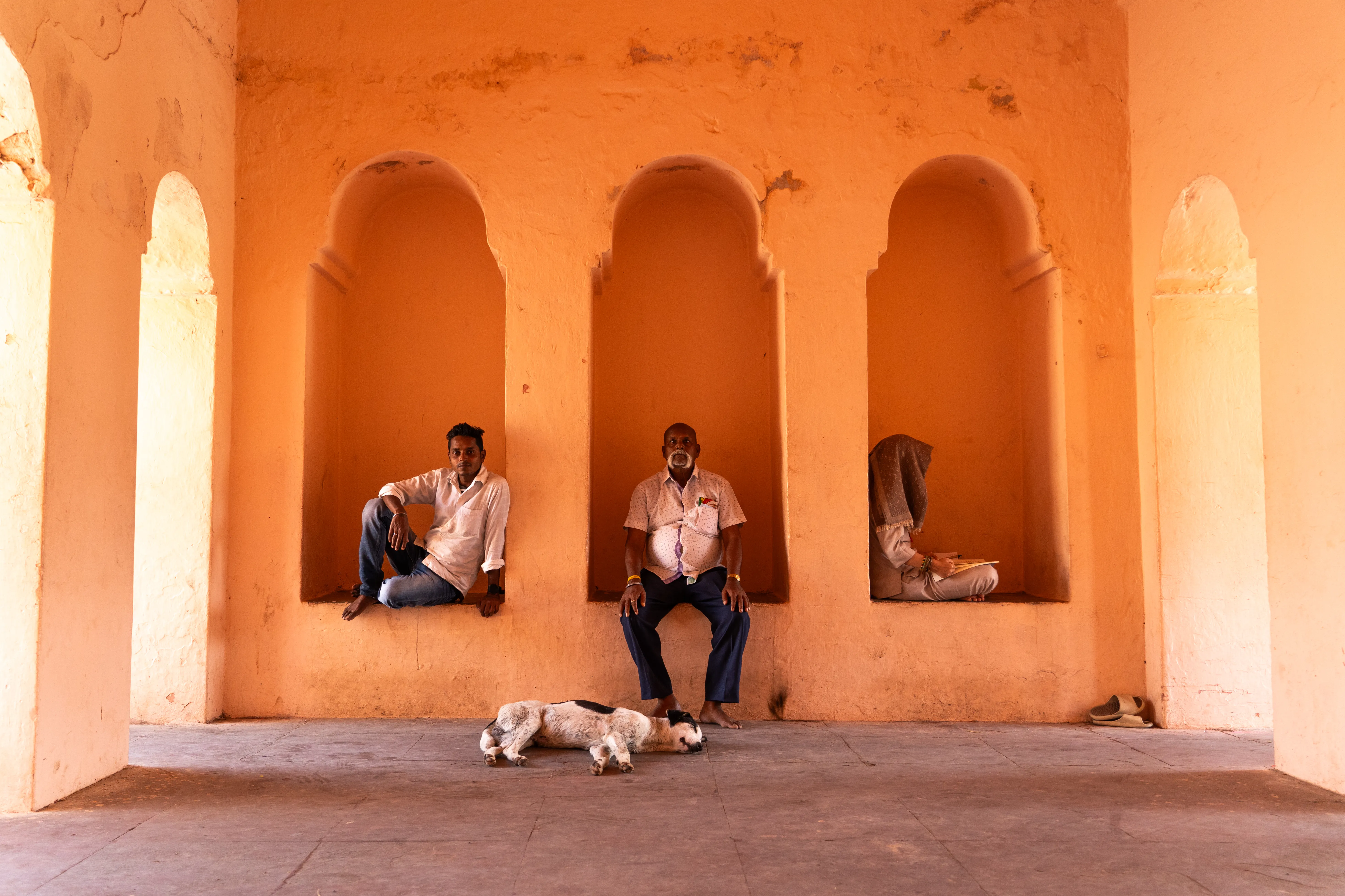 Three men and a sleeping dog in the archways
