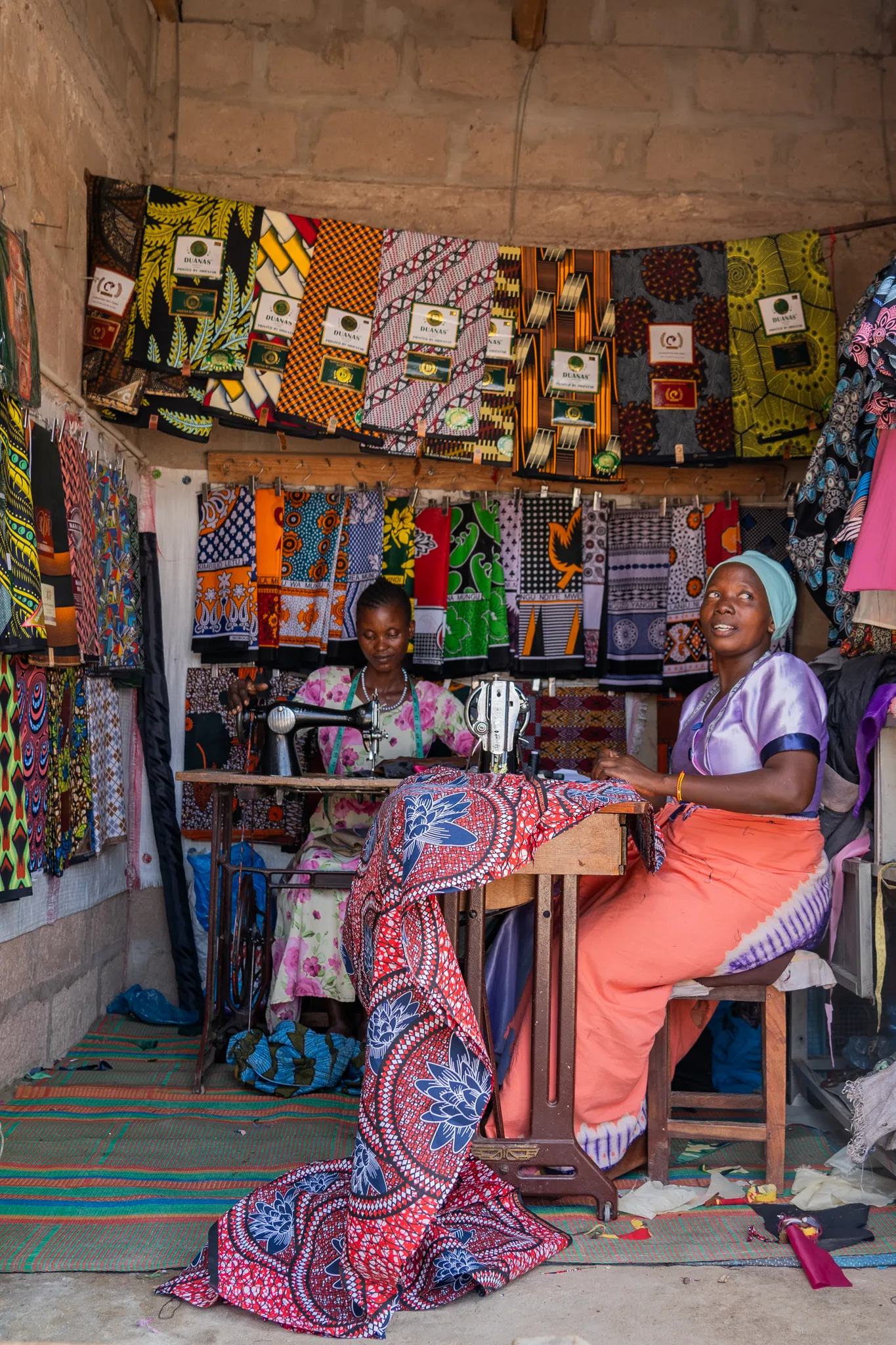 Seamstresses at work in a fabric stall, Tanzania