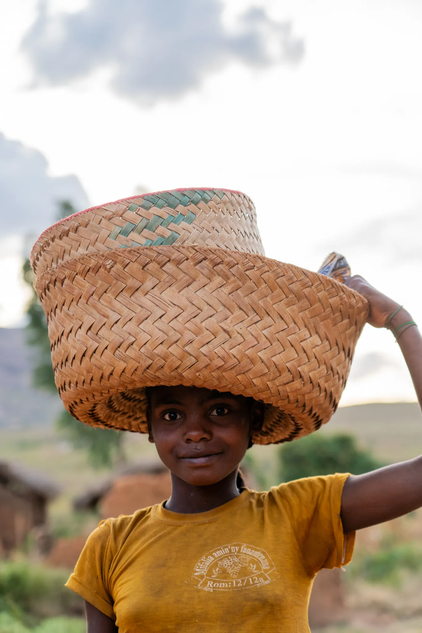 Girl carrying nested baskets on her head