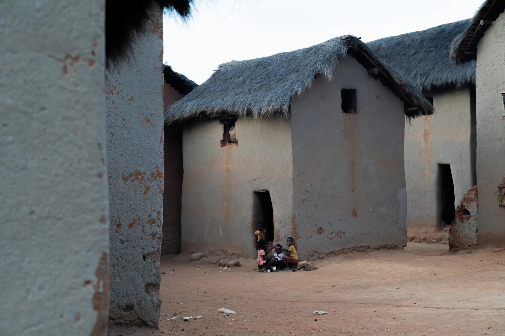 Children outside thatched houses