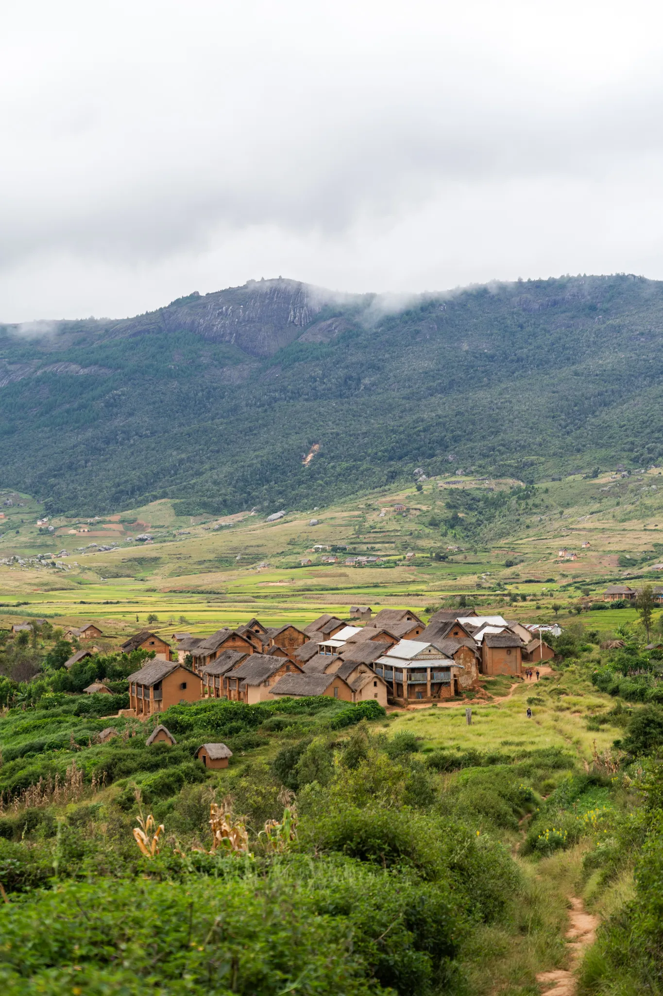 Village below a misty mountain