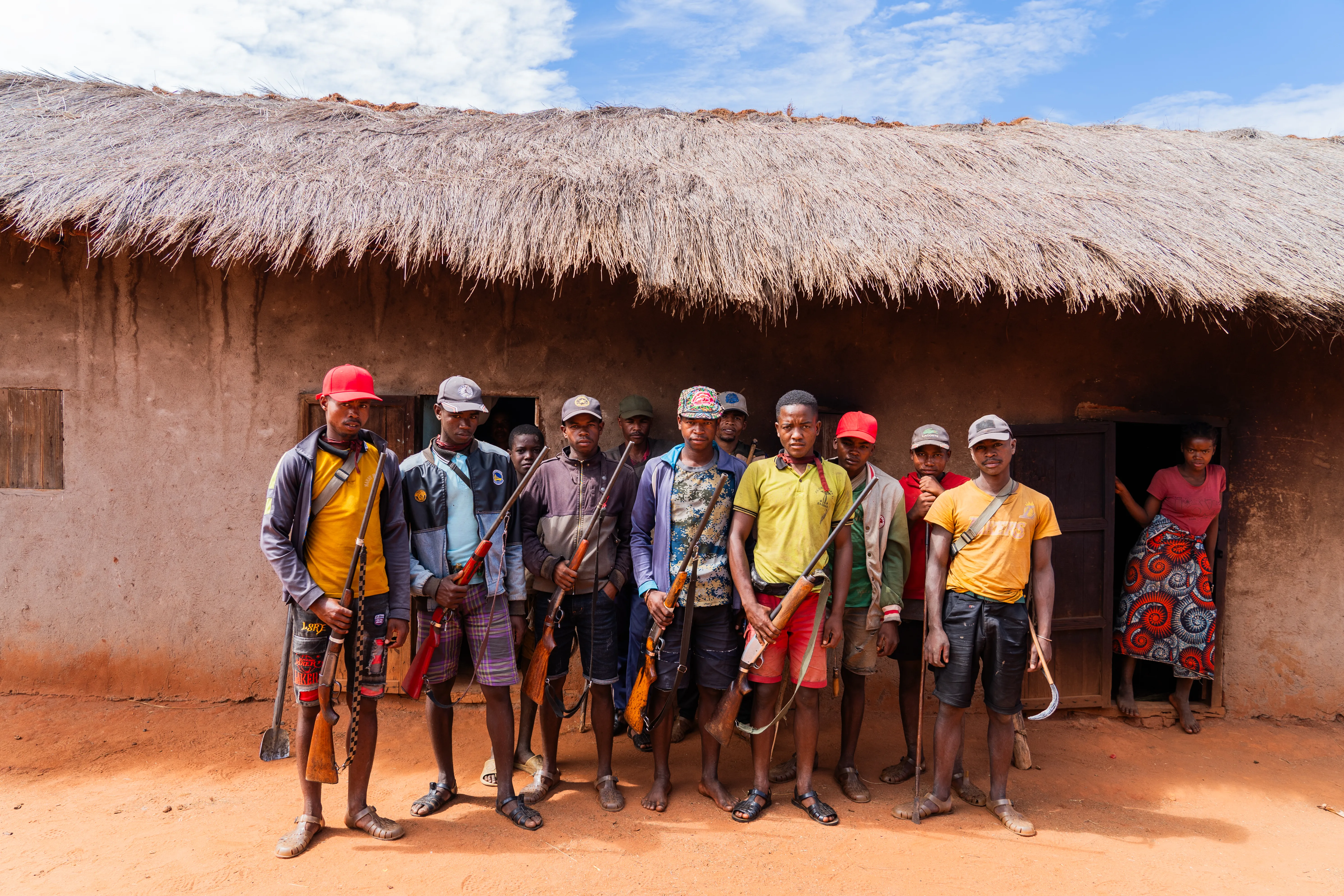Group portrait of hunters with rifles