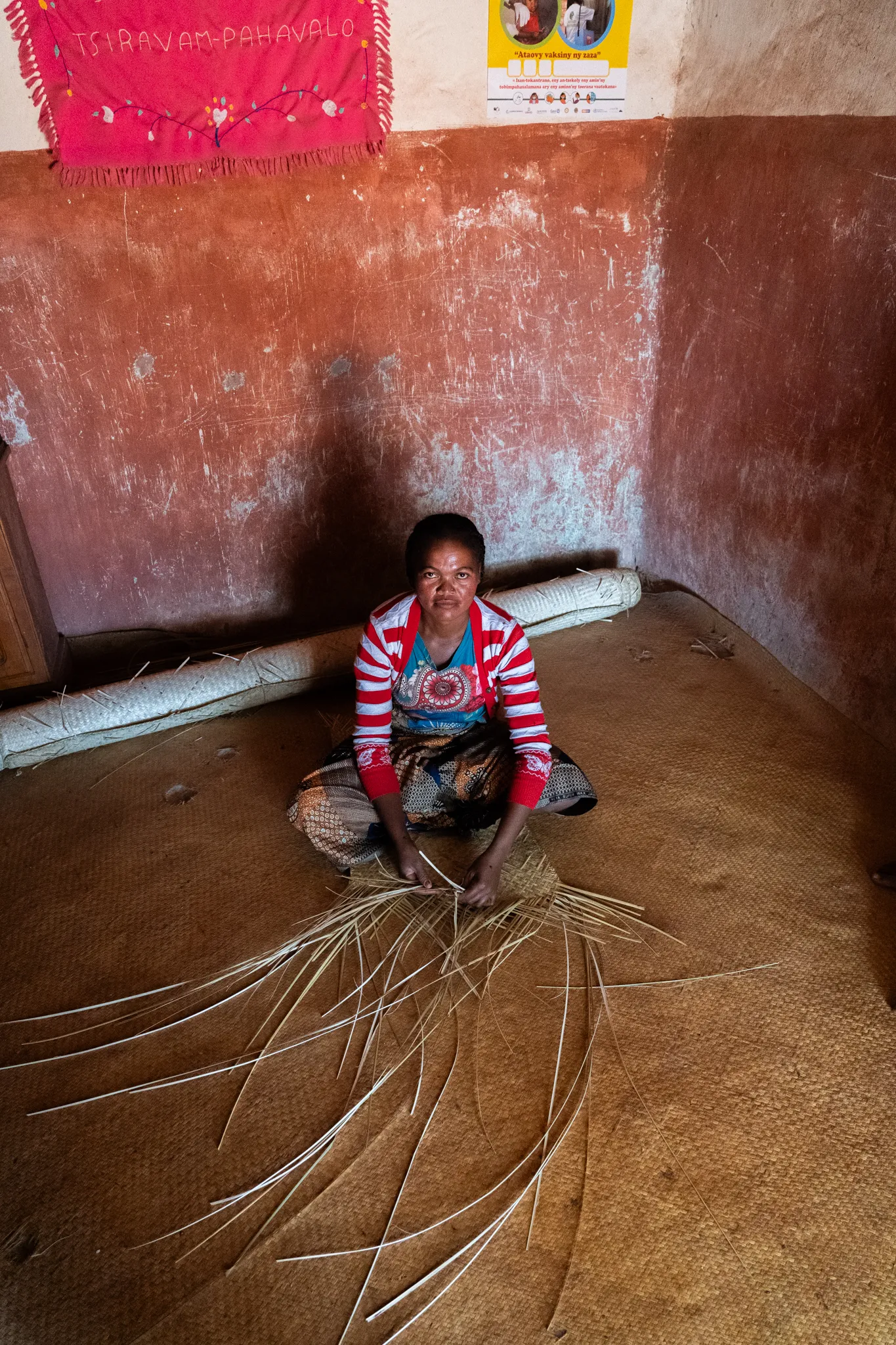 Woman weaving with raffia strands