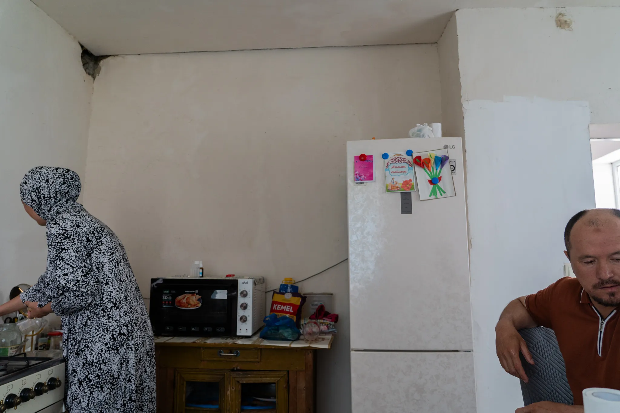 Woman in kitchen, family at home, Kazakhstan