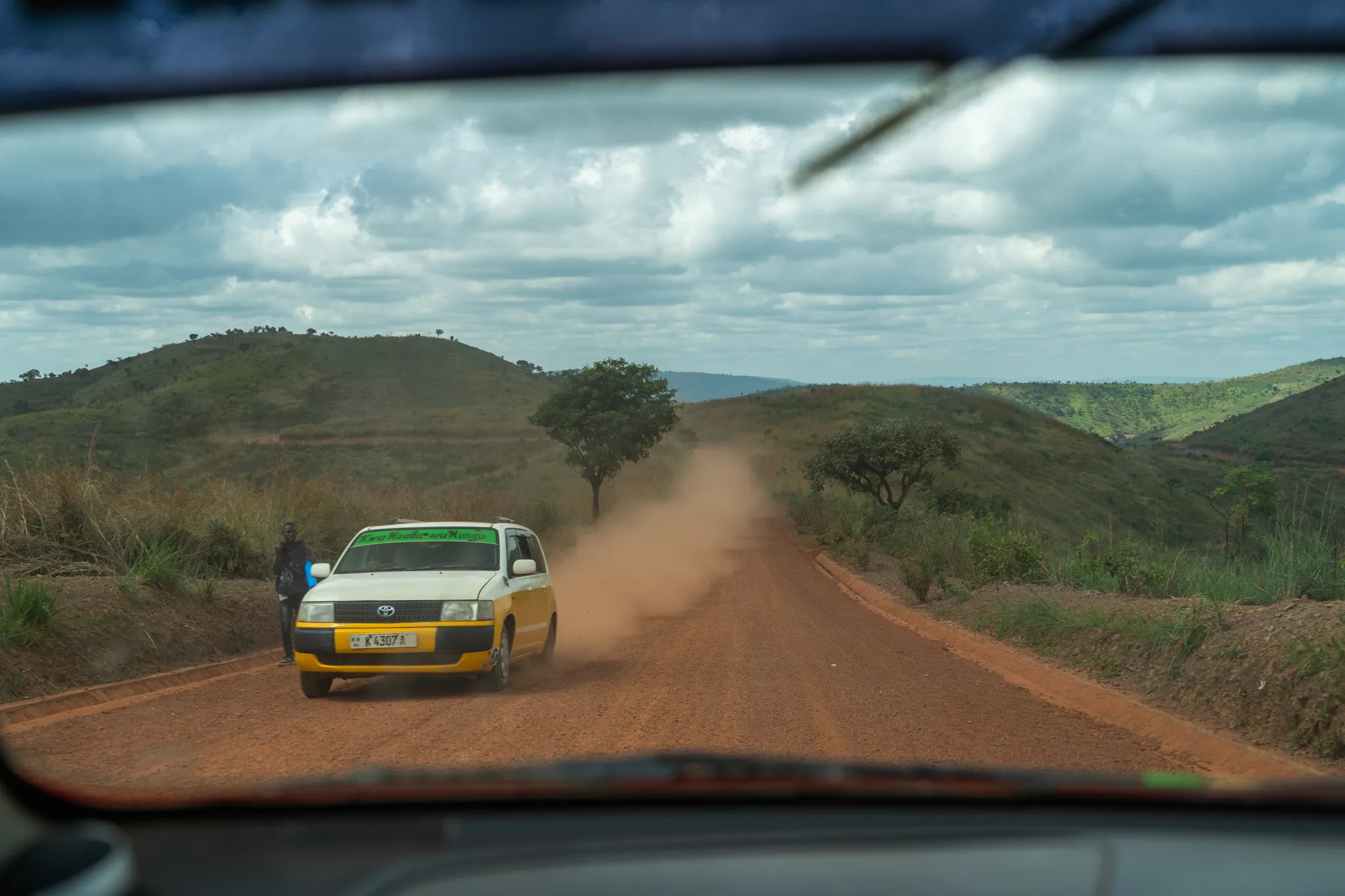 Car going down dirt road, Burundi