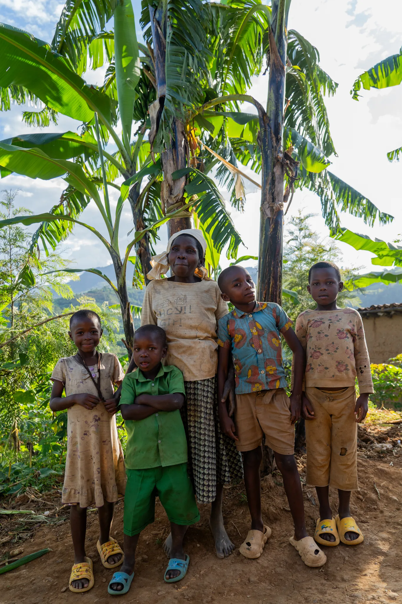 Grandmother and grandchildren under banana trees, Rwanda