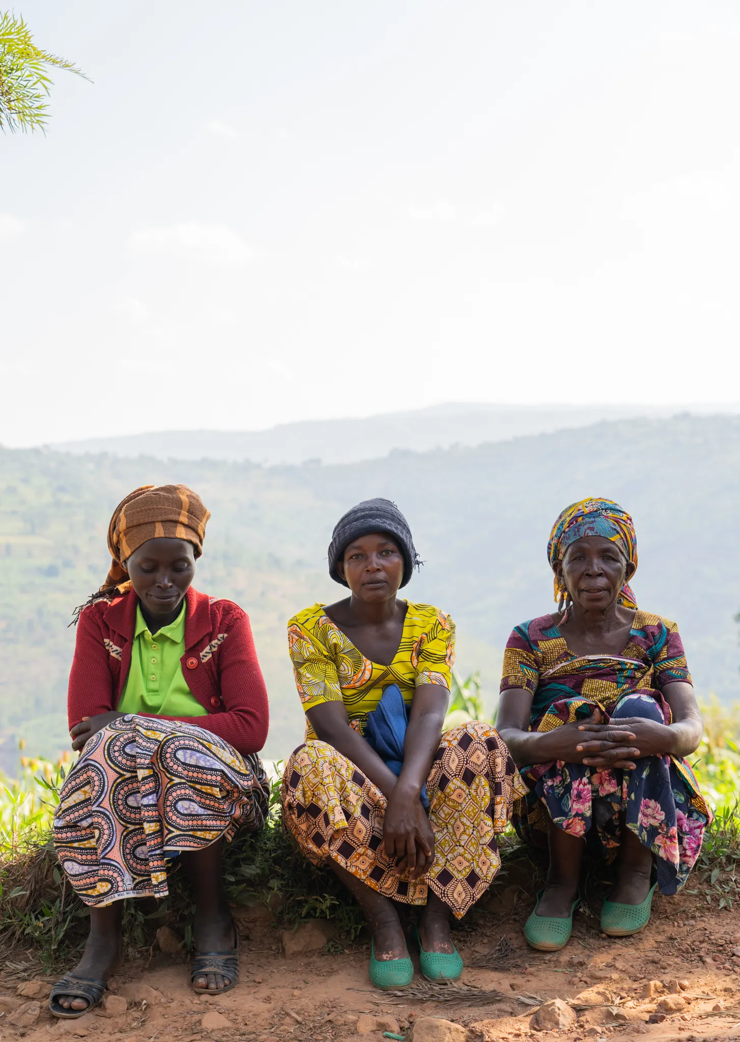 Three women seated above the valley, Rwanda