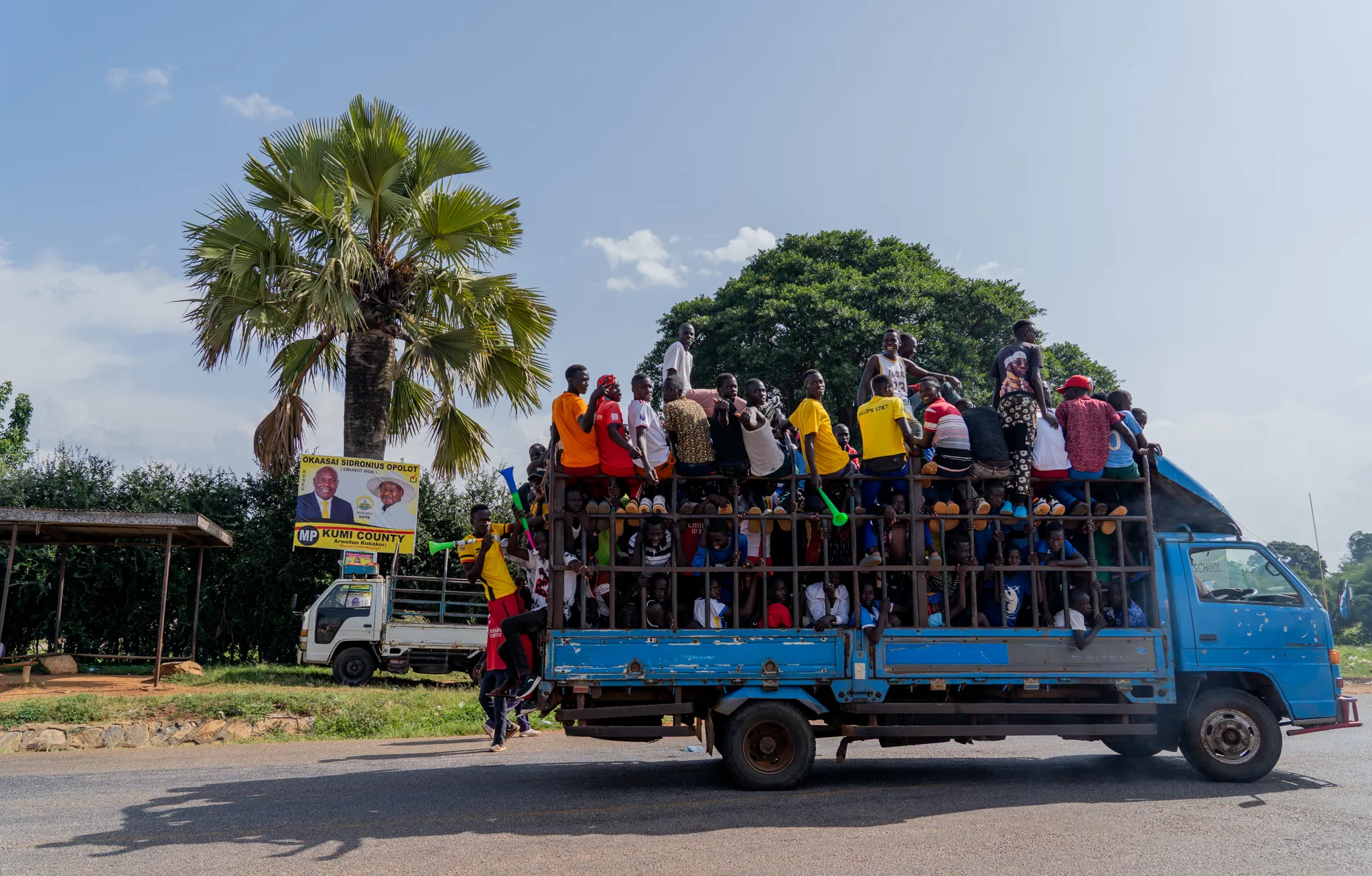 Crowd packed onto a truck bed during campaign season, Uganda