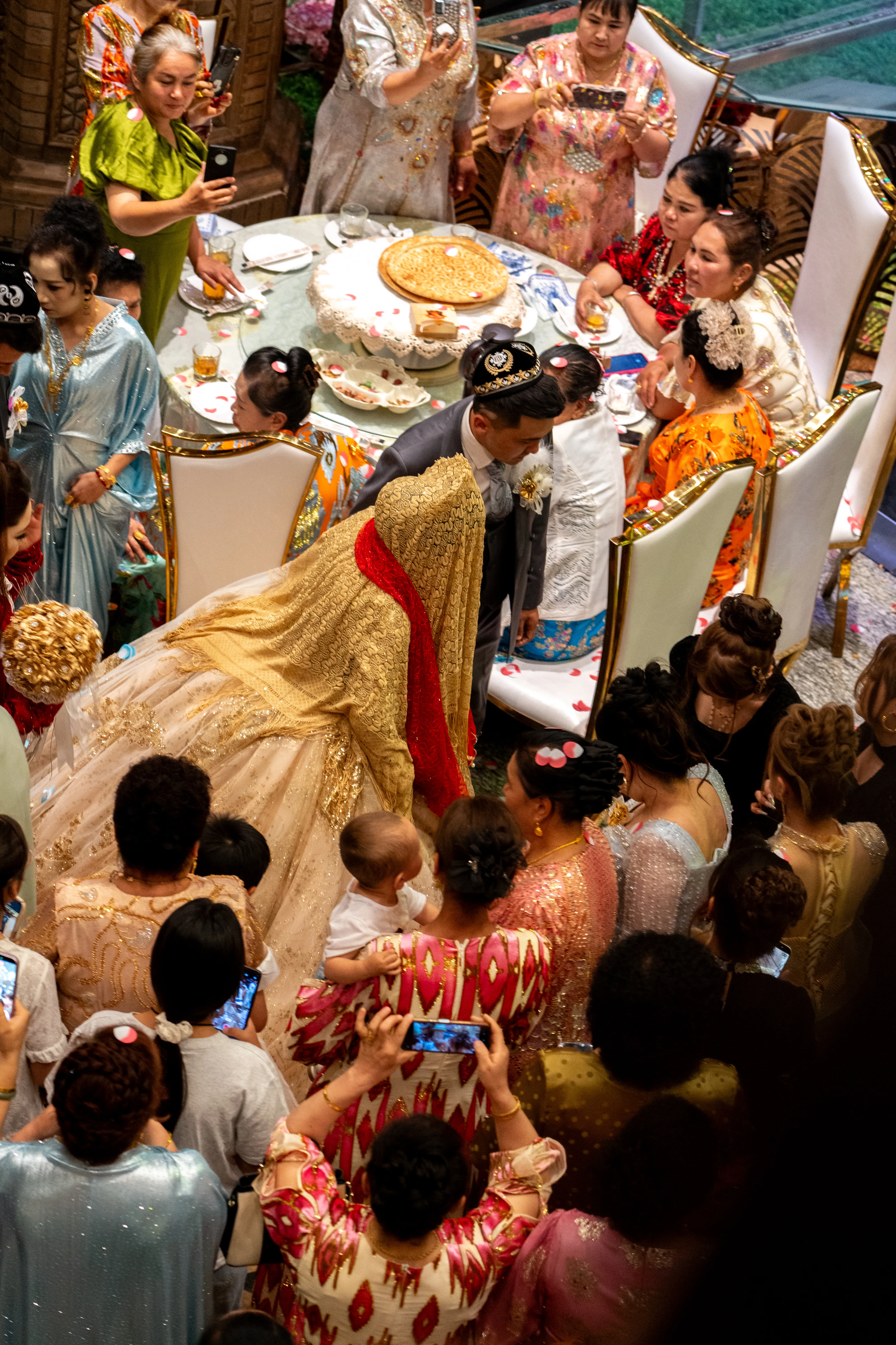 Guests gather around the table at a Uyghur wedding, China