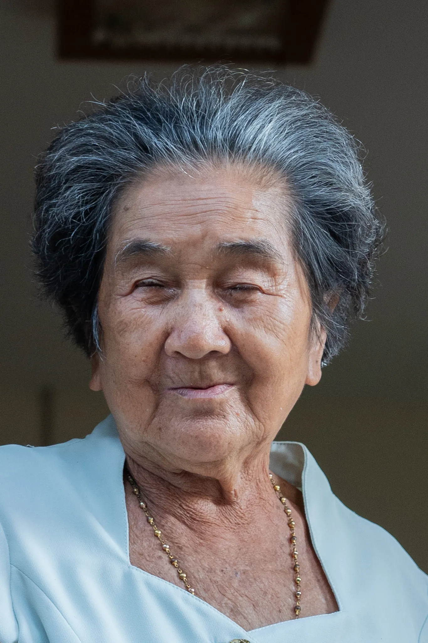Portrait of an elderly woman in a gold necklace