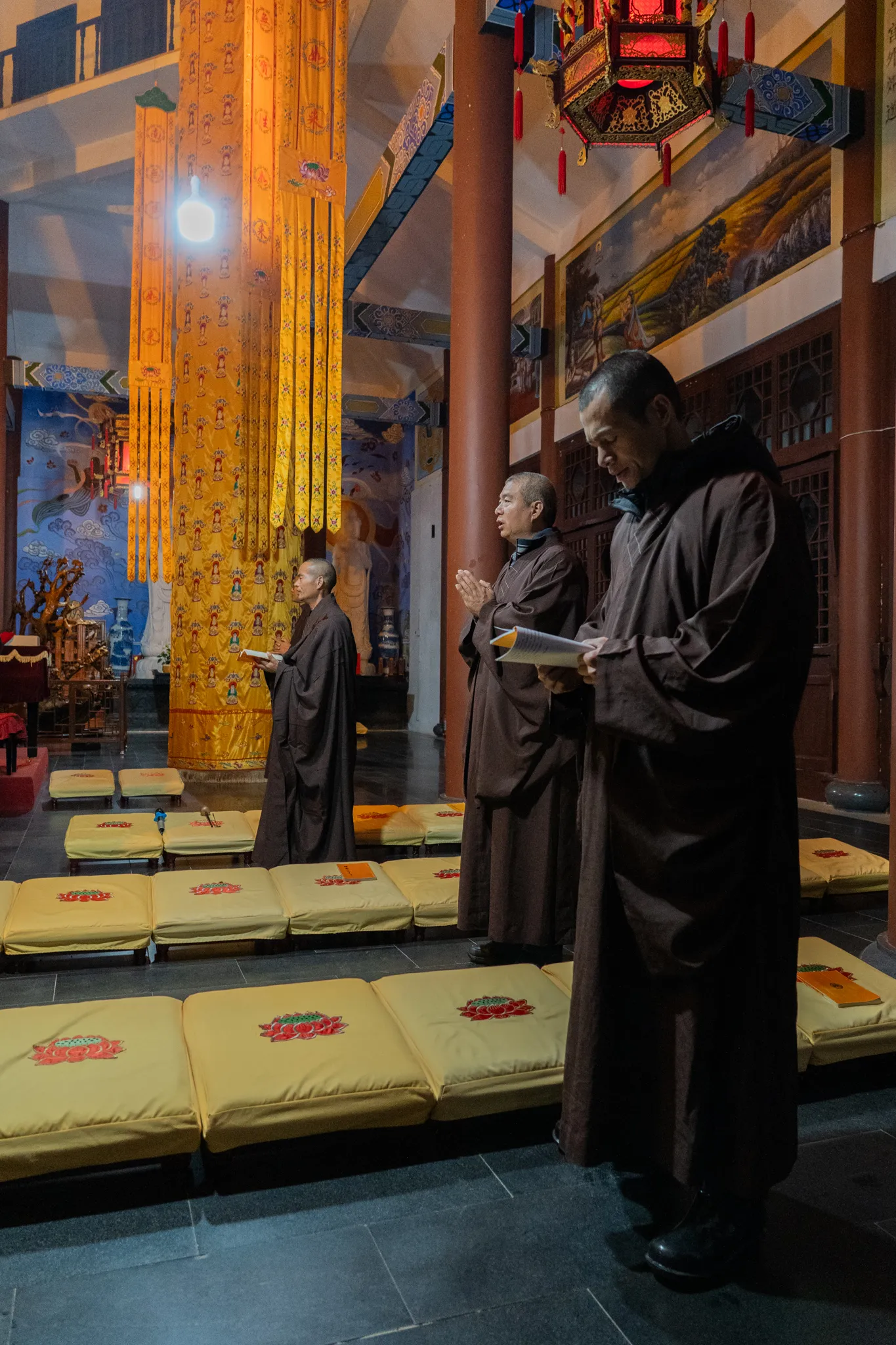 Monks reciting sutras among lotus cushions